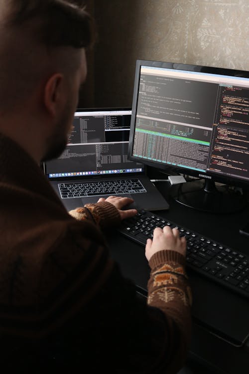 person using different screens for coding