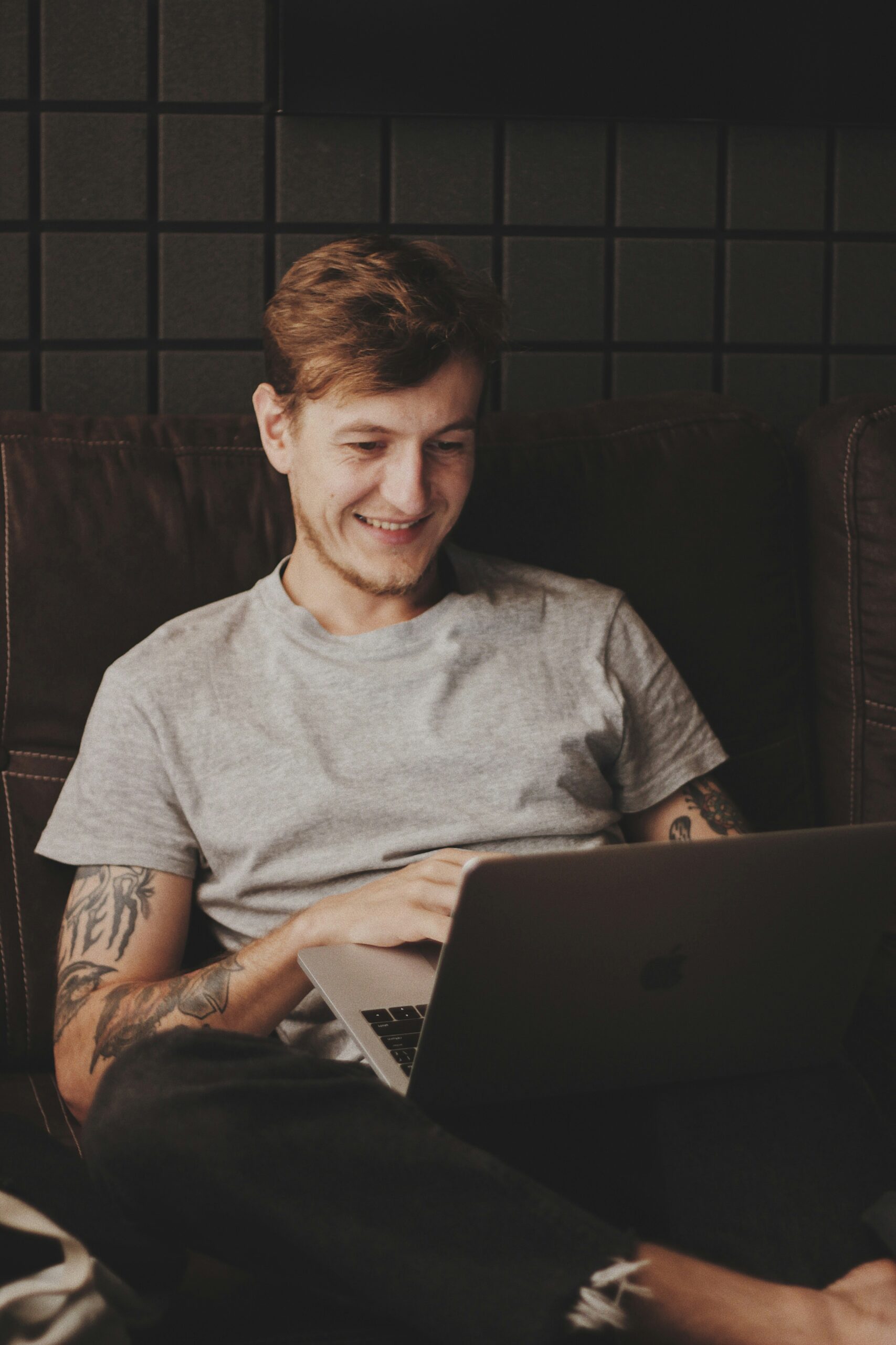 A person working on a laptop, representing the flexibility of web design CMS solutions that can be tailored to local or national needs.