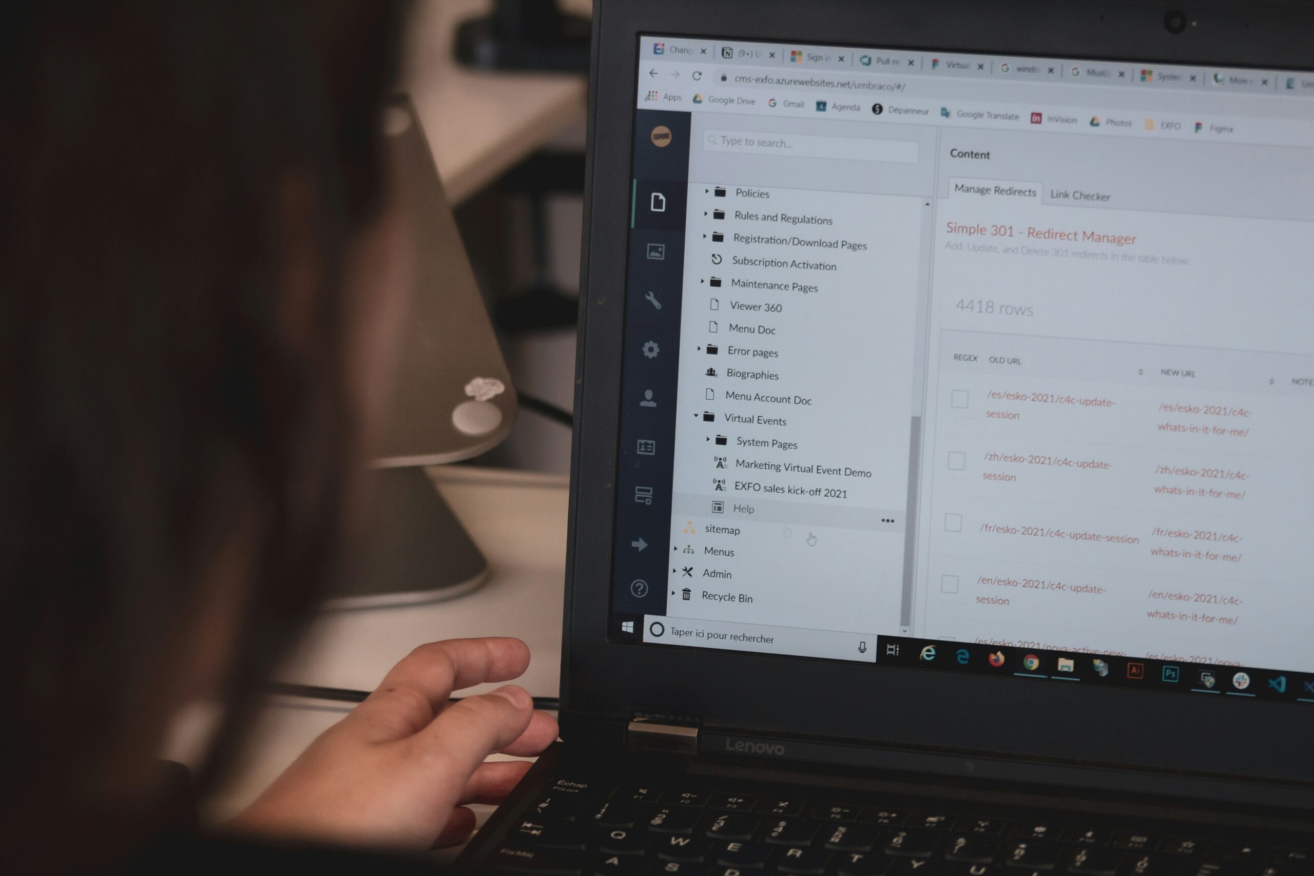 A person working on a laptop with a CMS dashboard open, representing the flexibility and control offered by open-source CMS platforms.