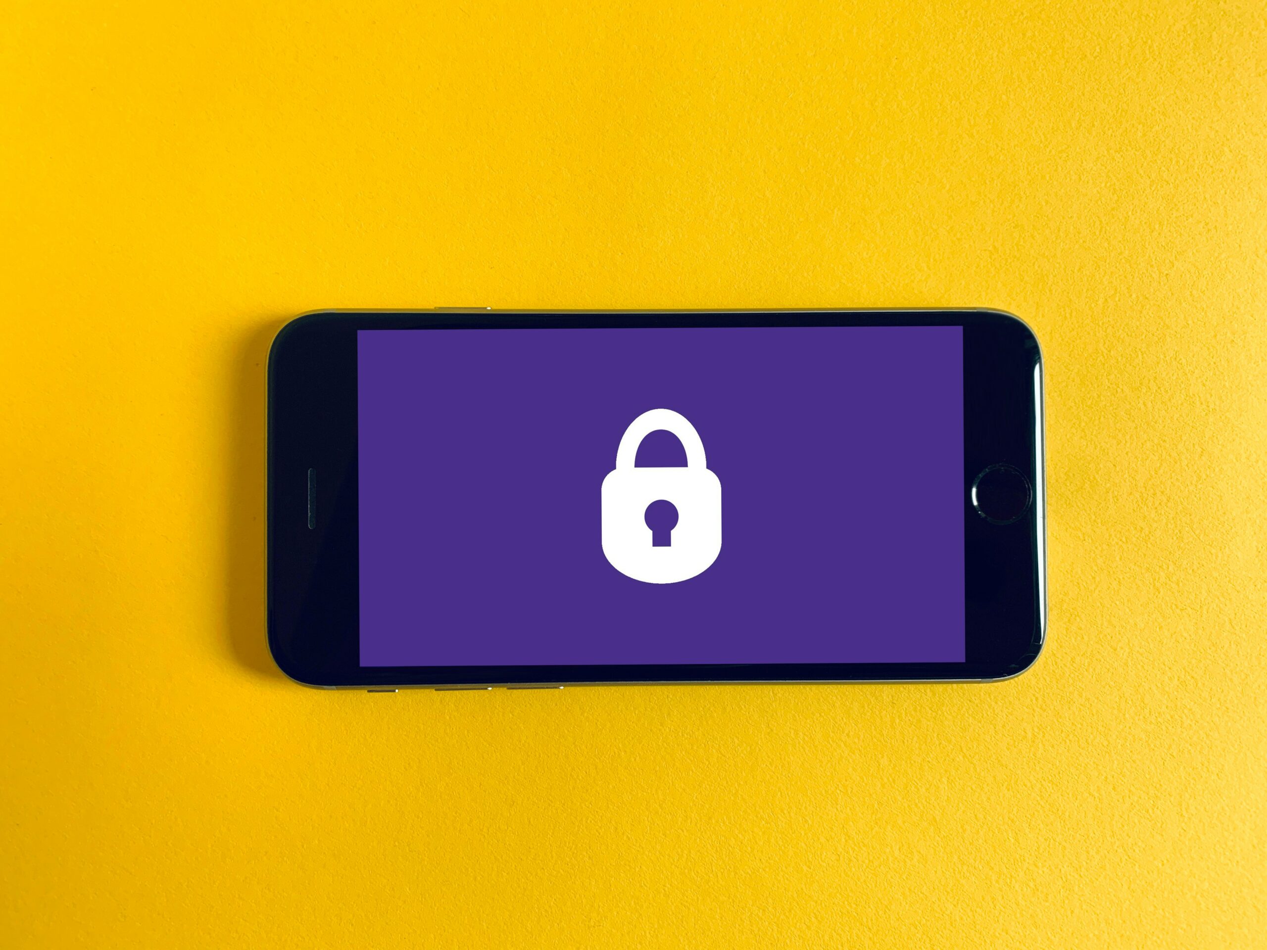 A smartphone displaying a lock icon, representing security measures in open-source vs. proprietary systems, including data protection and vulnerability management.