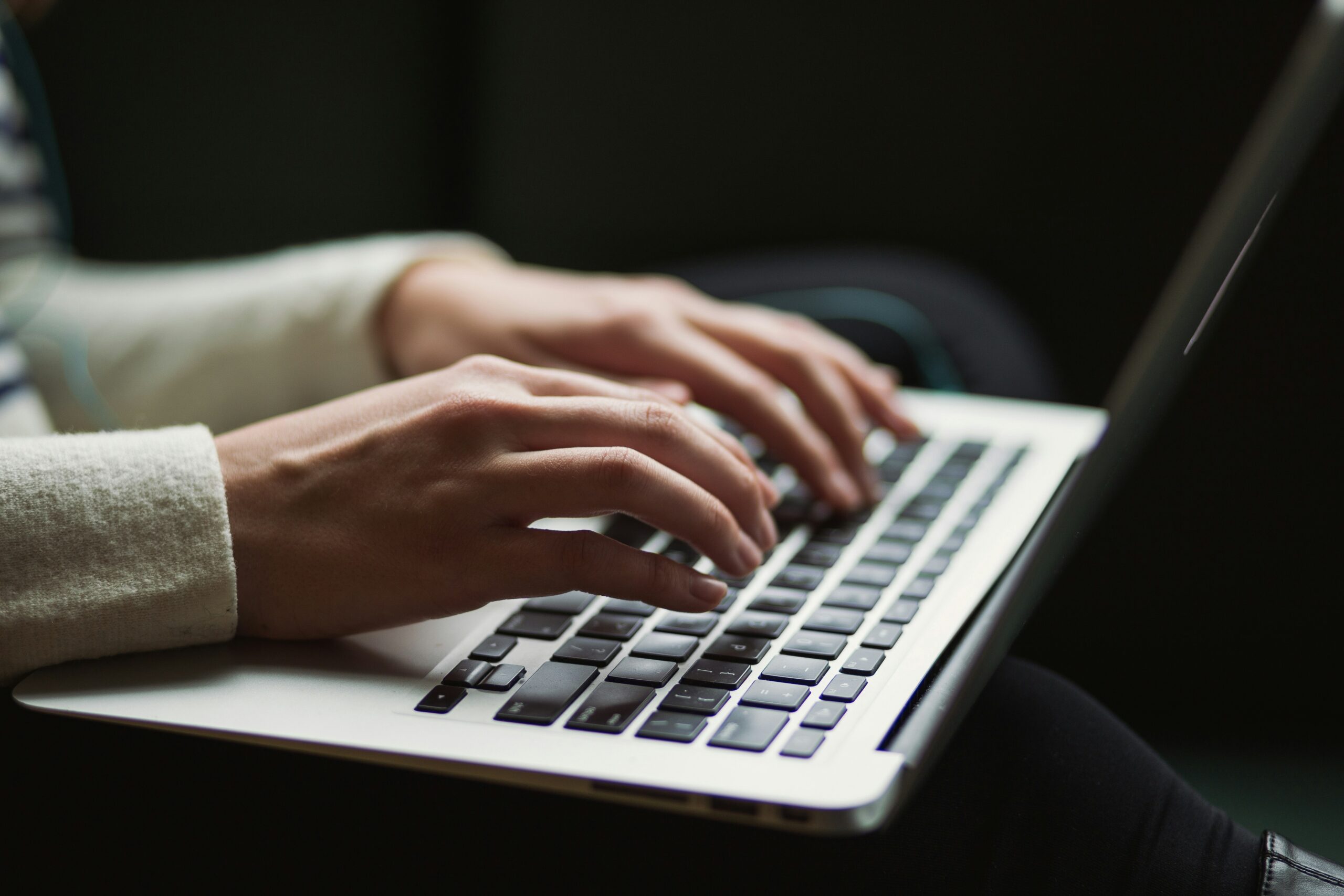 A close-up of hands typing on a laptop keyboard, symbolizing the process of understanding custom server-side solutions for efficient web development.