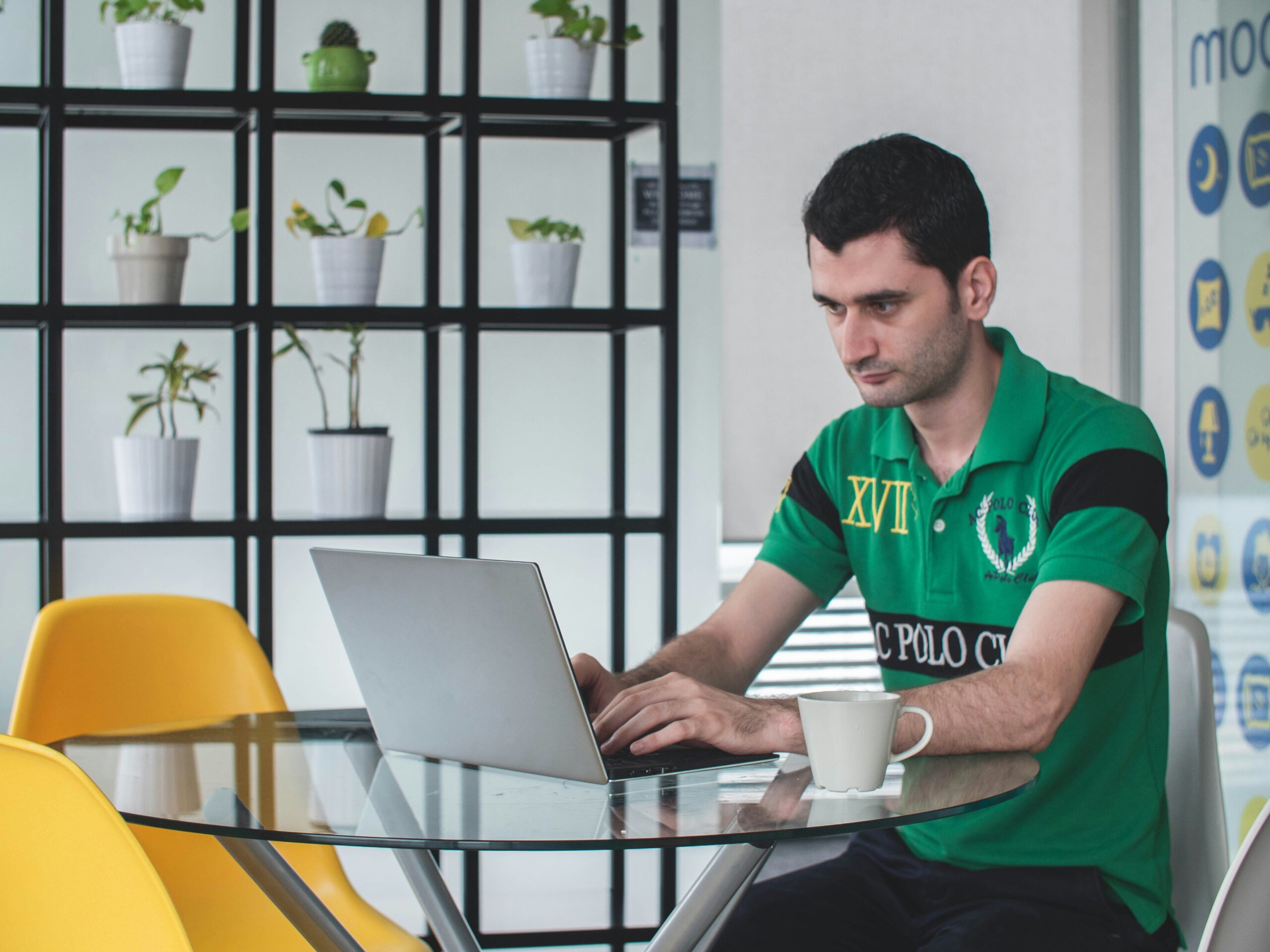 A focused professional working on a laptop at a modern workspace, analyzing and comparing different service models for an informed decision.