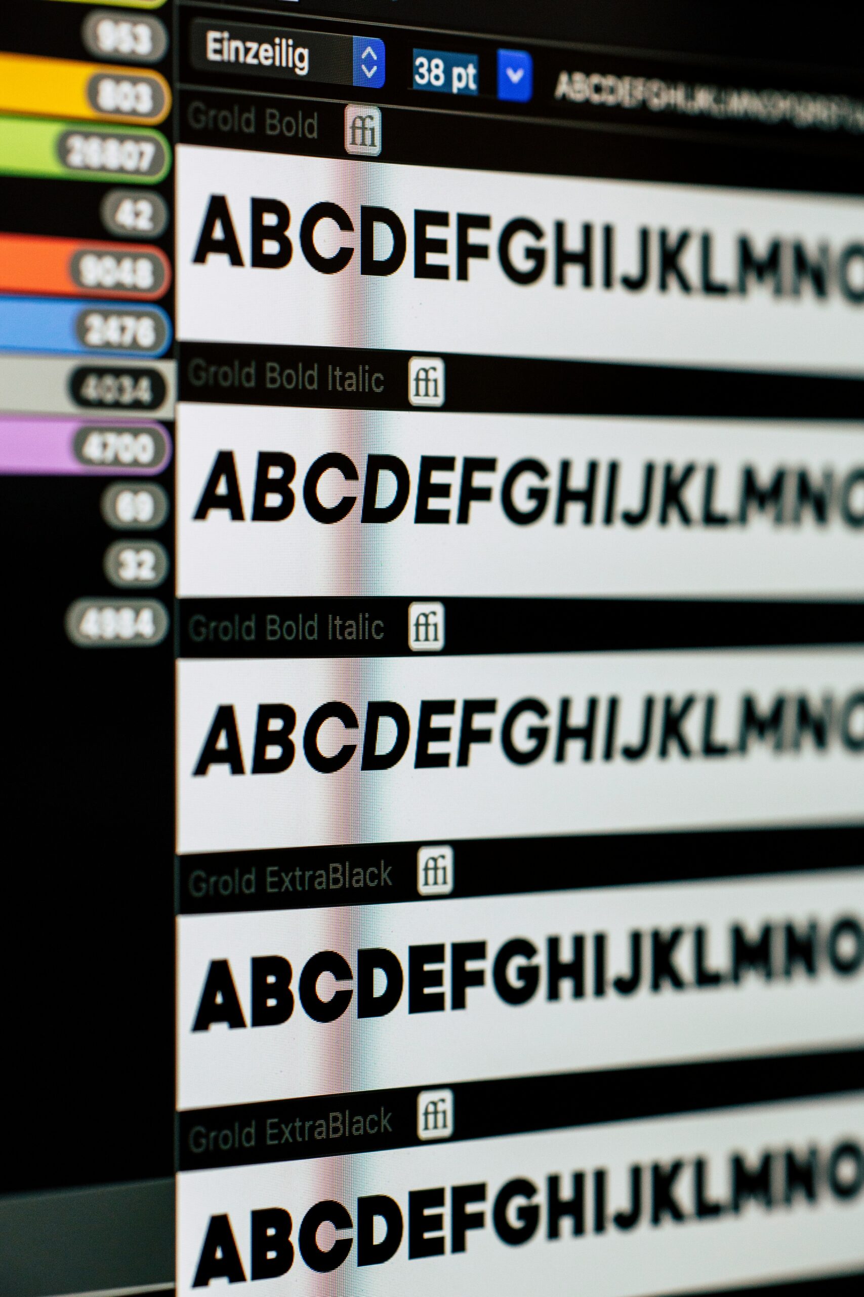 A close-up of a computer screen displaying different font styles, including bold, italic, and extra black variations, with a menu showing font settings and size options.