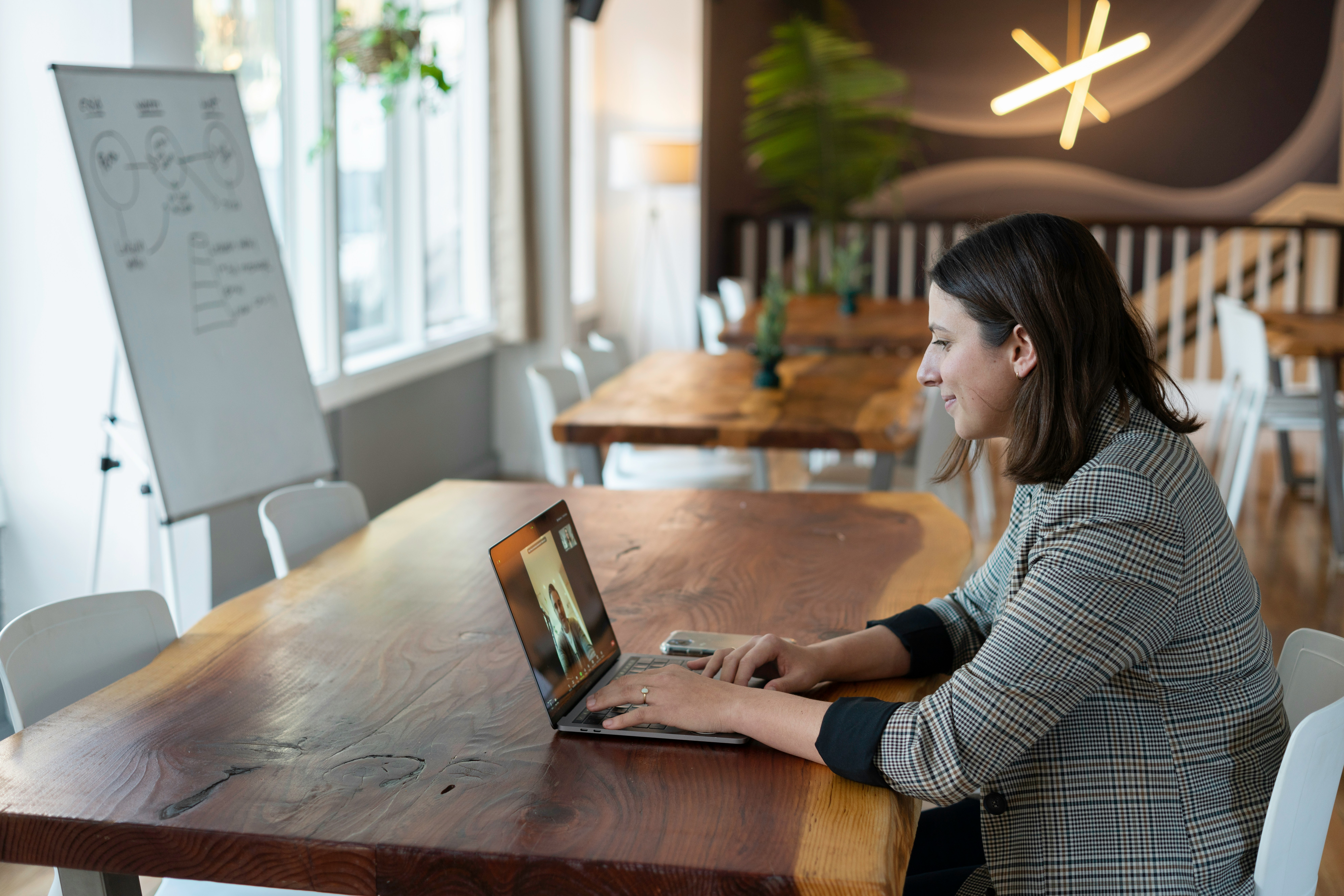 A professional engaged in a virtual meeting in a modern workspace, representing the process of ensuring ongoing support and maintenance for projects.