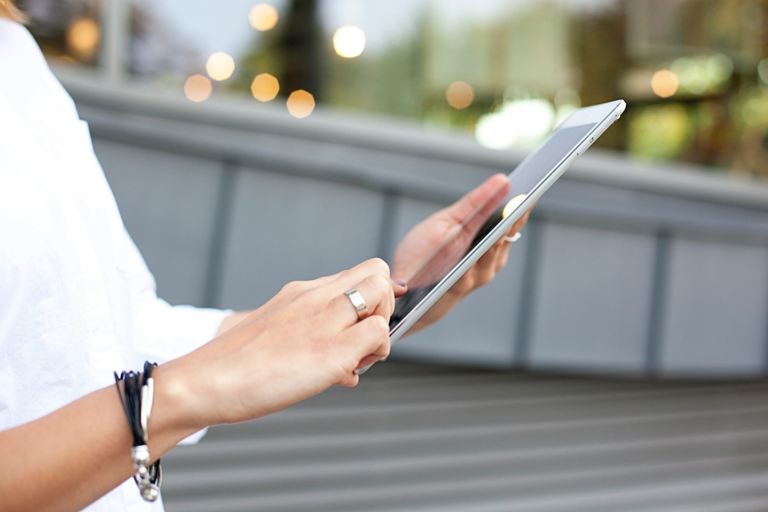 A person interacts with a tablet interface, highlighting the importance of responsive design flexibility compared to rigid, ready-made design templates across platforms. | Day by Day Digital A person interacts with a tablet interface, highlighting the importance of responsive design flexibility compared to rigid, ready-made design templates across platforms.