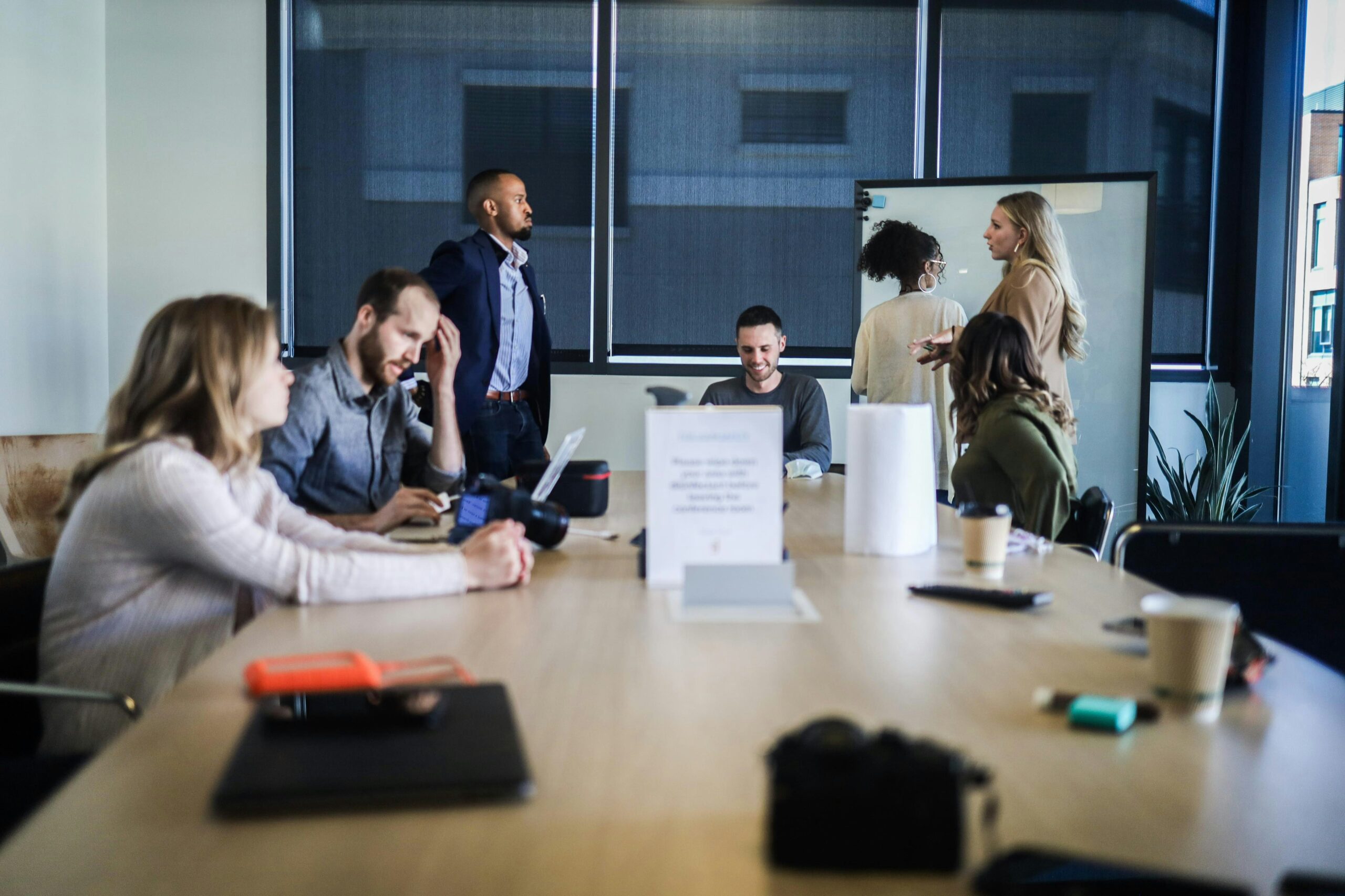 A group of people collaborating around a conference table, representing team planning for an effective SEO content strategy.