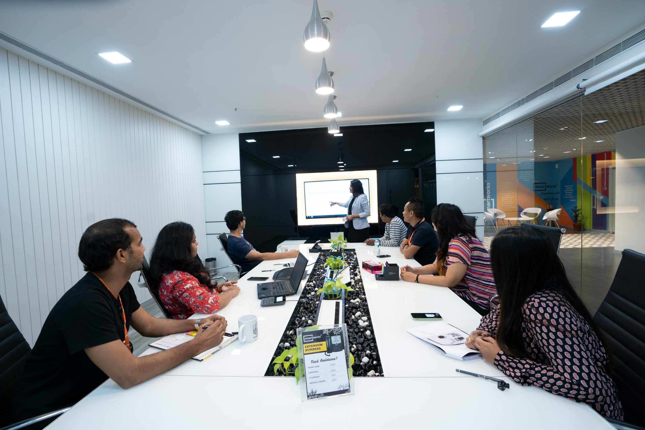 A team in a conference room attentively watching a presenter explain a strategy on a screen, reflecting collaboration on best practices for creating and optimizing SEO content. | Day by Day Digital A team in a conference room attentively watching a presenter explain a strategy on a screen, reflecting collaboration on best practices for creating and optimizing SEO content.