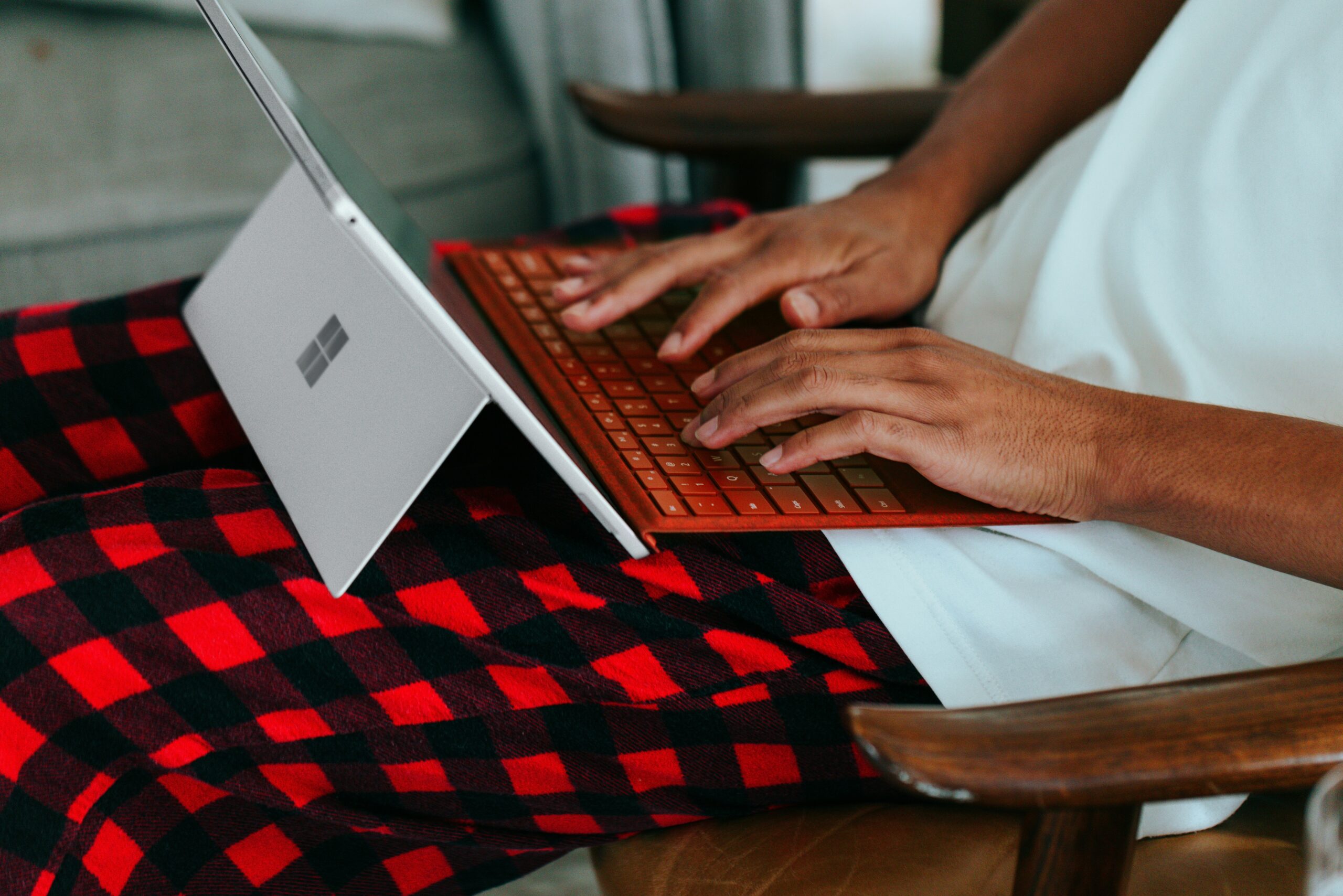 A person typing on a tablet with a keyboard on their lap, symbolizing the effort to build authoritative backlinks that enhance SEO visibility and domain authority. | Day by Day Digital A person typing on a tablet with a keyboard on their lap, symbolizing the effort to build authoritative backlinks that enhance SEO visibility and domain authority.