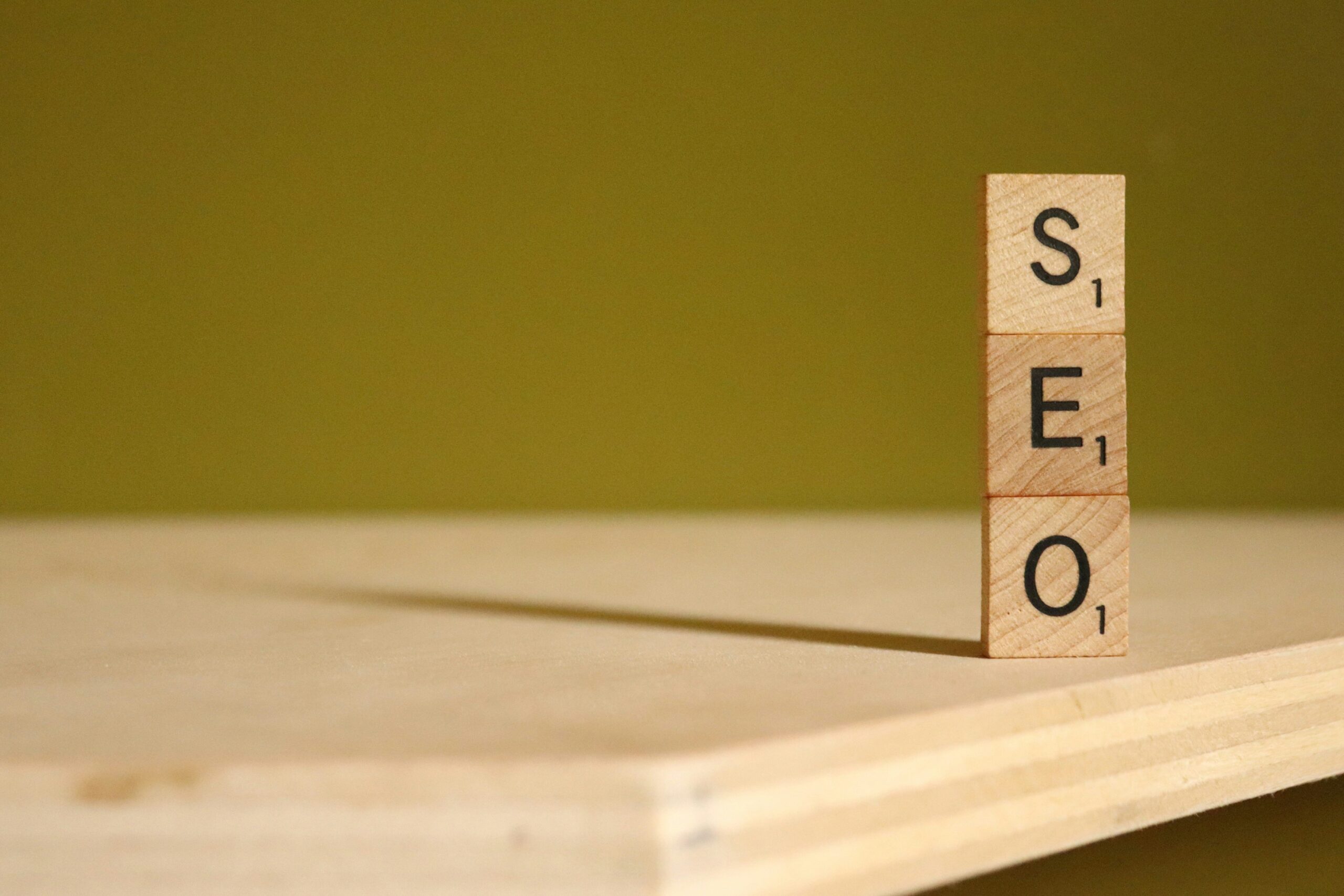 Wooden blocks stacked to spell “SEO,” representing essential search engine optimization services for improving online store visibility.