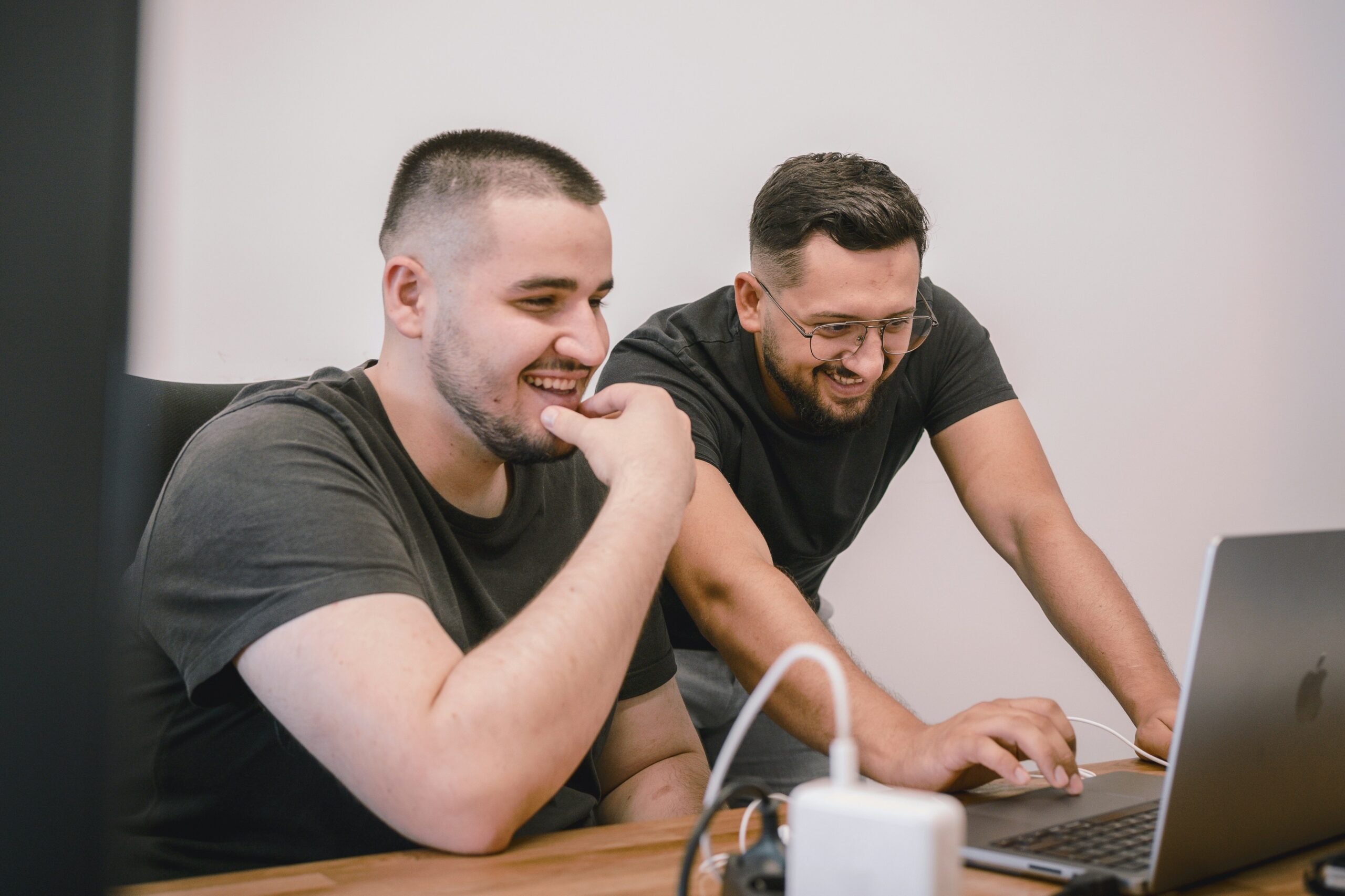 Two marketers smile as they refine their link prospecting and outreach strategy, aiming for stronger connections and higher-quality backlinks.