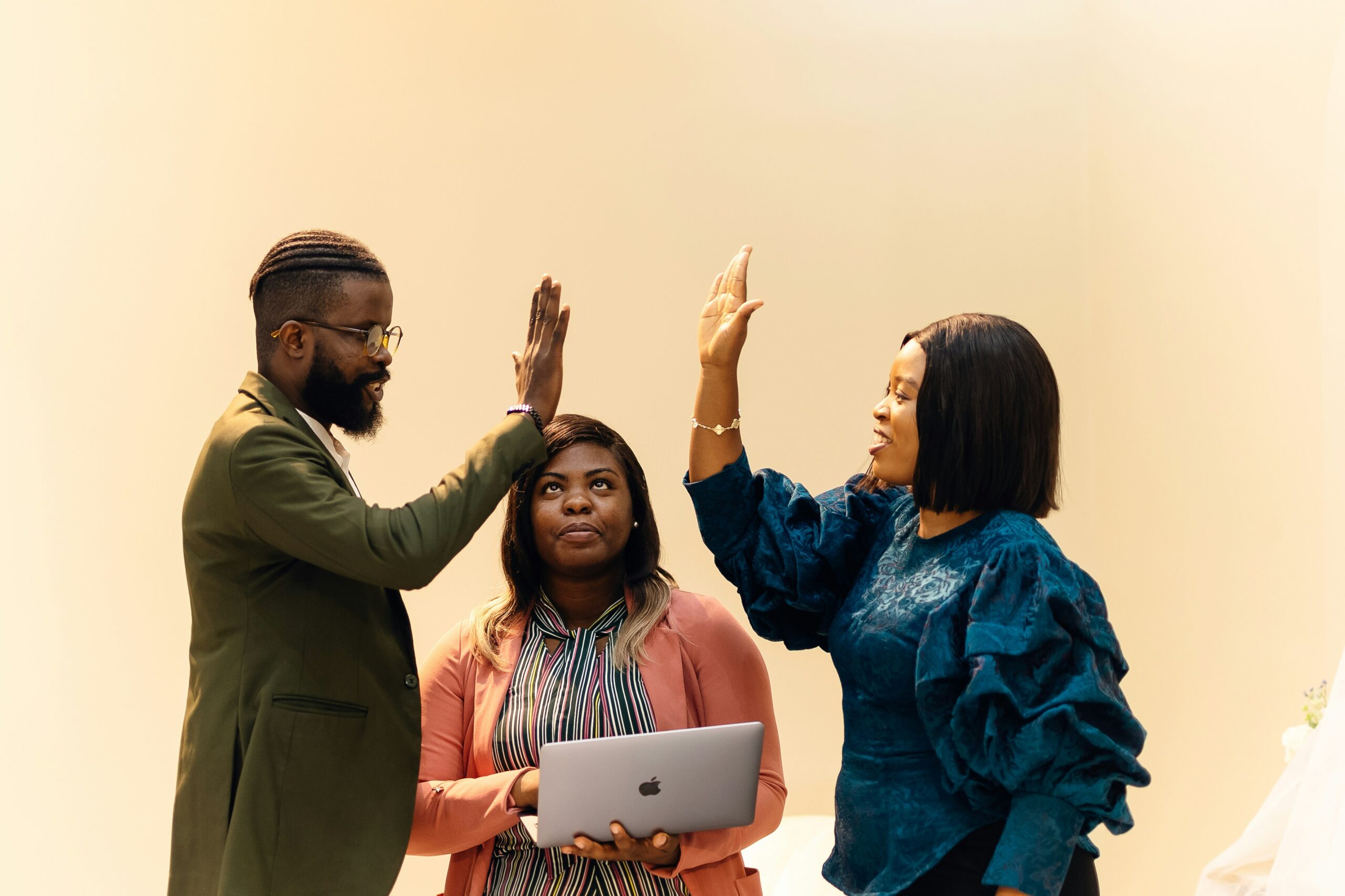 A group of professionals celebrates a successful SEO strategy with high-fives, highlighting the value of continuous performance analysis in link building.