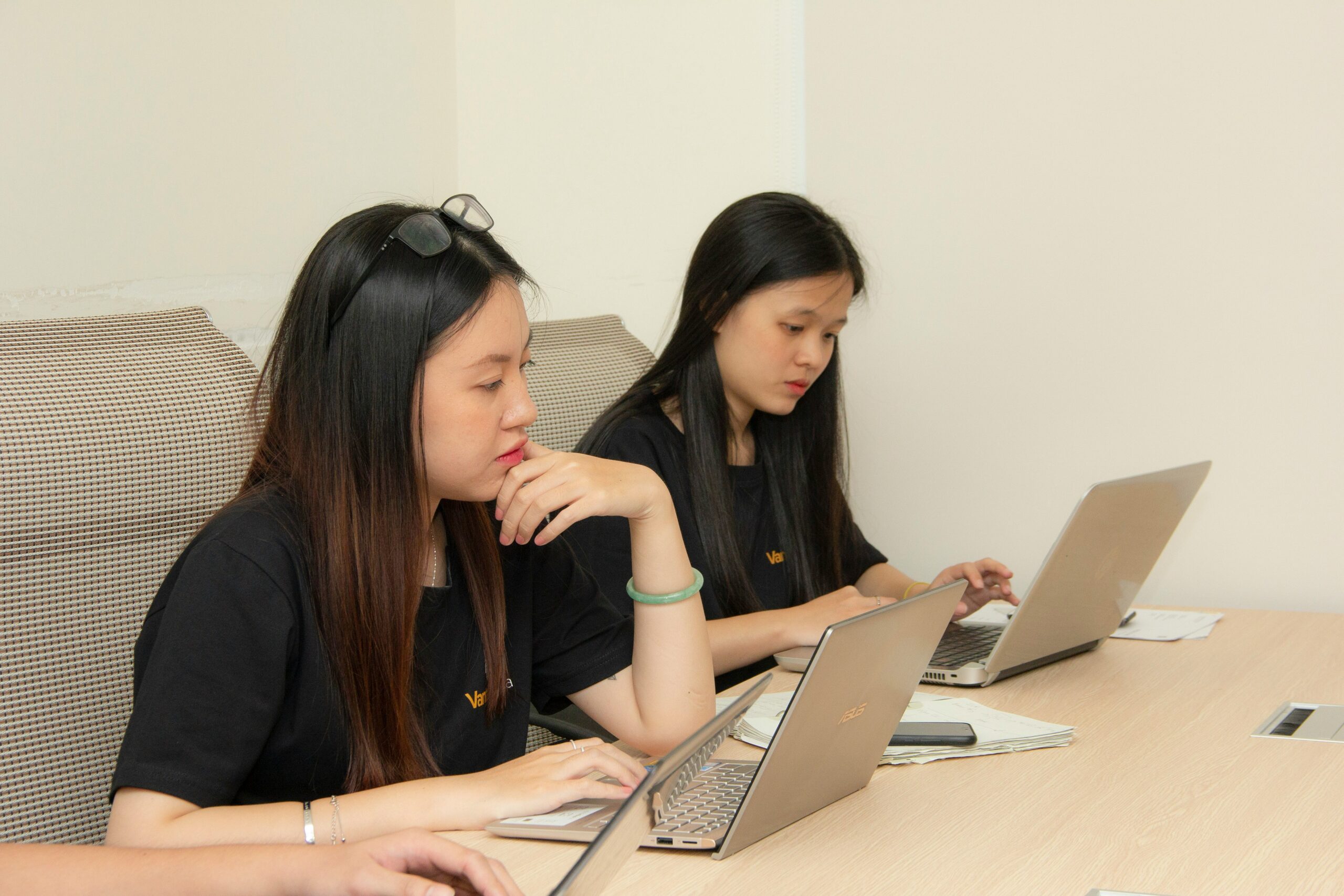 Two women analyzing data on their laptops, representing the importance of link building case studies in understanding strategy outcomes and SEO success. | Day by Day Digital Two women analyzing data on their laptops, representing the importance of link building case studies in understanding strategy outcomes and SEO success.